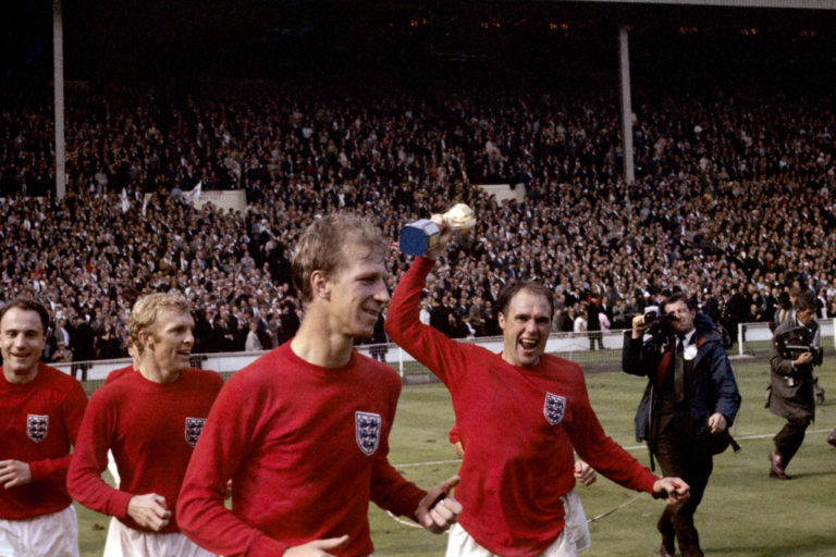 England's George Cohen, Bobby Moore, Jack Charlton and Ray Wilson, with trophy, celebrate after winning the World Cup in 1966